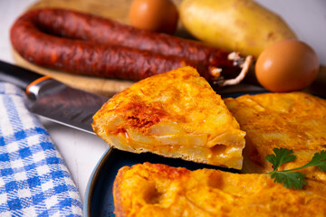 Traditional Spanish omelette cooked with chorizo, potatoes and onion. Traditional tapas of Spanish gastronomy.