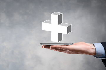 Businessman hold 3D plus icon, man hold in hand offer positive thing such as profit, benefits, development, CSR represented by plus sign.The hand shows the plus sign