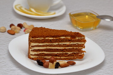 honey cake on a plate with nuts and tea for dessert