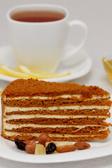honey cake on a plate with nuts and tea for dessert