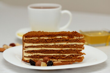 honey cake on a plate with nuts and tea for dessert