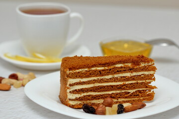 honey cake on a plate with nuts and tea for dessert