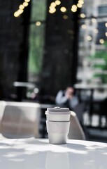 Eco bamboo coffee cup on the background of the cafe. eco-concept