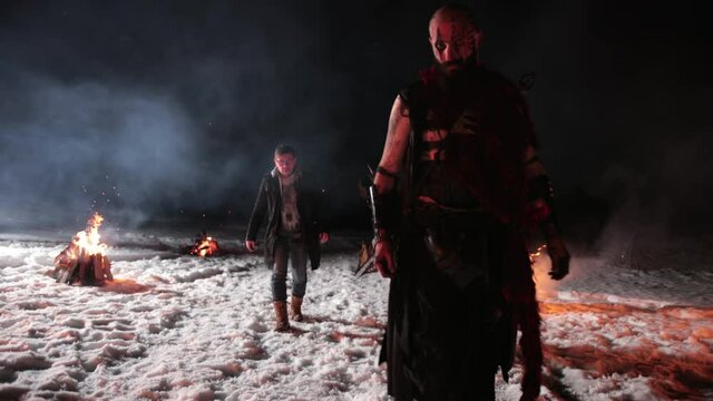 The viking warrior goes for crossed swords with his opponent to start battle. Black metal weapon on the front