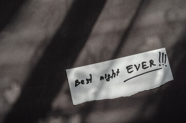 Handwritten note Best Night Ever on a white piece of paper.