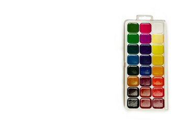 Watercolor paints and brushes, top view. Hobbies and creativity. white background. Set of colorful  paints palette