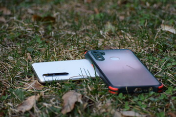 Beautiful picture of a mobile and mobile cover in green grass. Selective focus, Selective Focus On Subject, Background Blur