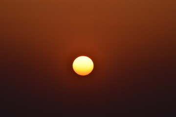 Orange big sun isolated on orange background. Sunset, Selective focus, Selective Focus On Subject, Background Blur