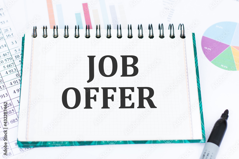 Poster text job offer on a notepad against the background of financial charts, planning concept. notebook w