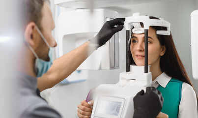 Young woman ready to computer 3d tomography of teeth and jaw in modern dental clinic