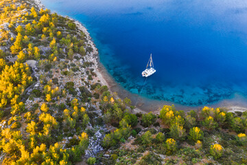 Aerial view of a catamaran yacht in the blue sea. Yachting, luxury vacation at sea.