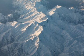 Aerial view of snowy mountains, top view of winter landscape