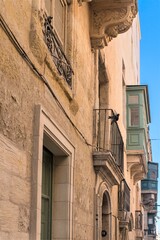 Malta, Marsaxlokk, August 2019. Pigeons on the facade of a Maltese house.