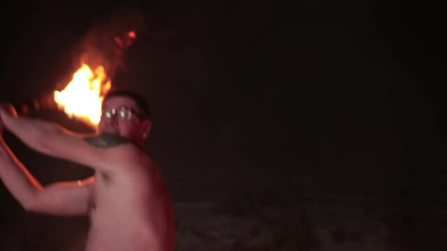 Battle an evil aggressive viking warrior in northern tattoos with a bare torso on burning fire swords with an opponent from our days wearing glasses