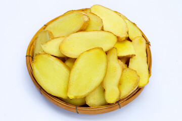 Ginger slices in bamboo basket on white