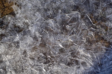 Abstract pattern of ice crystals and ice needles during an ice drift close-up.