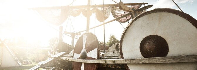 Old wooden viking snekkja longship type, close-up. Nautical vessel, tall ship, traditional craft, vintage, landmark, history, past, historical reenactment, nordic culture - obrazy, fototapety, plakaty