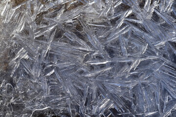 Abstract pattern of ice crystals and ice needles during an ice drift close-up.
