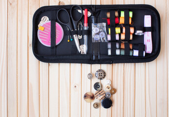 Sewing and objects for sewing on wooden background.