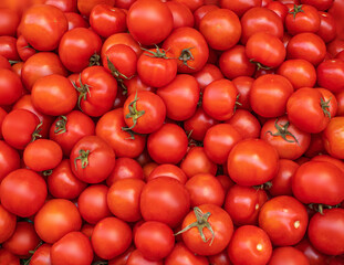 Organic Tomatoes closeup. Red tomatoes as a background on a agriculture Summer market . top view.