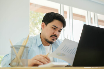 close up adult  middle eastern man reading company's profit statistics report with stress emotion during work at home for healthy lifestyle concept