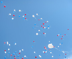 balloons in the sky white blue red