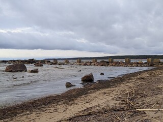 ruined and old sea pier in the evening in spring against the background of the sea and sky