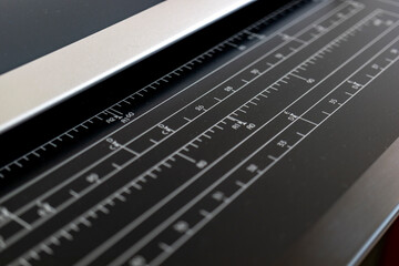 
plotter printer, technological tool. Ruler section close-up to measure the size of the paper to be put on top.