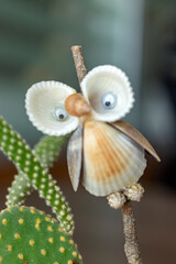 Owl figure made of seashells, cute and close-up.