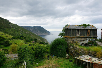Ancient building, horreo, on a mountain overlooking the coast