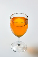 A dice falling into a glass of orange liquid caused a splash