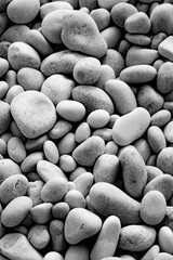 Closeup black and white image of pebbles on beach