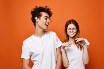 young couple white t-shirts fun fashion orange background