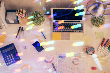 Double exposure of data drawing hologram over topview of study desk background with computer. Concept of Ai.