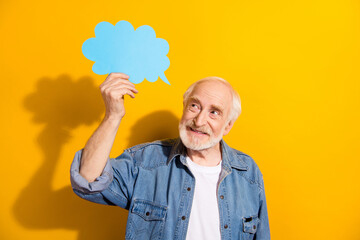 Portrait of optimistic handsome grey beard old man hold bubble wear shirt isolated on orange...