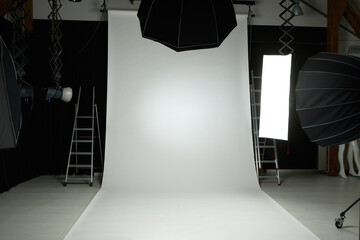 Photography flash strobe firing in studio with white background