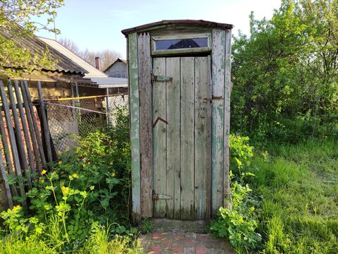 Old rustic wooden toilet in a countryside in summer
