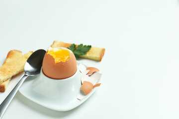 Concept of tasty breakfast with boiled egg on white background