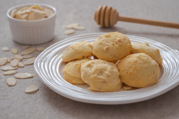 Butter cookies with almond on white plate.