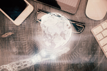 Double exposure of map hologram drawing over desktop. Top view. International connection concept.
