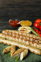 Concept of tasty food with grilled sausage on wooden table