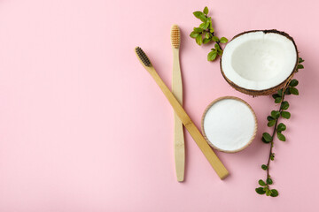 Oral care accessories on pink background, space for text