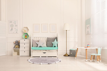 Cozy baby room interior with crib and toys