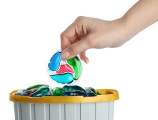 Woman taking laundry capsule out of box against white background, closeup