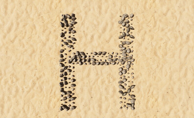 Concept or conceptual stones on beach sand handmade symbol shape, golden sandy background, sign of H. 3d illustration metaphor for education, nature, summer, sunny, seaside and tropical