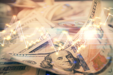 Double exposure of forex graph drawing over us dollars bill background. Concept of financial...