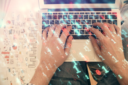 Multi exposure of man's hands typing over computer keyboard and data theme hologram drawing. Top view. Technology concept.
