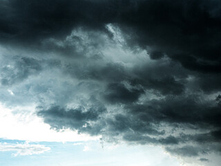 Naklejka na ściany i meble Dramatic dark grey clouds sky with storm and rain.