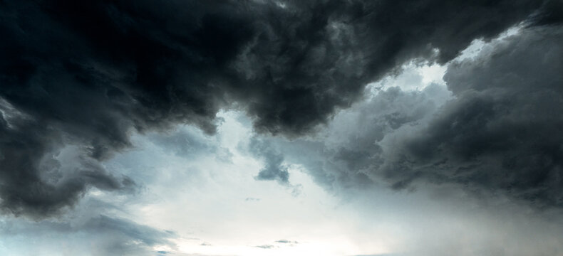 Panoramic Dramatic dark grey clouds sky with storm and rain.