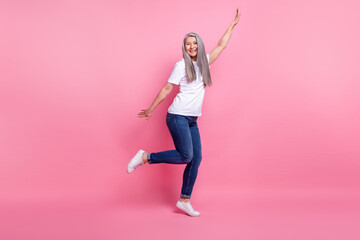 Fototapeta na wymiar Full length body size view of attractive cheerful grey-haired woman dancing having fun isolated over pink pastel color background